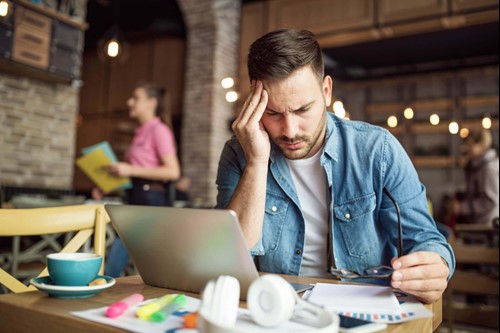 An employee with his head in his hands