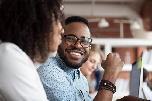 an employee smiling to their colleague