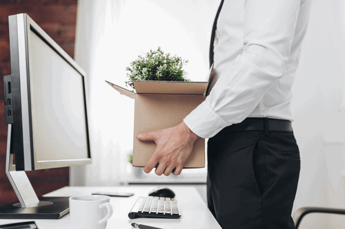 An employee packing their belongings after being made redundant.