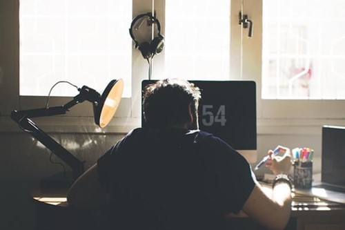 A worker working from home whilst caring for his family.