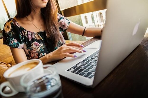 An employer typing on a laptop